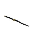 A Lady's gold plated Omega wristwatch on black leather strap, dial width 16 mm.