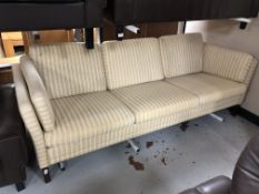 A 20th century Scandinavian three seater settee in cream striped fabric