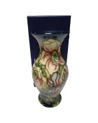 A Moorcroft vase decorated with lilies, boxed.