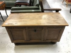An 18th century carved oak coffer on bun feet