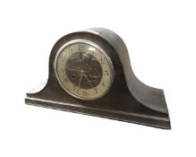 An oak cased mantel clock