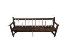 An antique pitch pine waiting room bench,