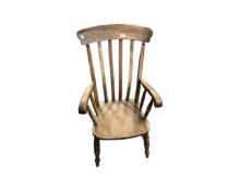 An antique elm farmhouse kitchen armchair