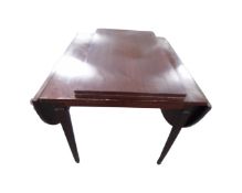 A late 20th century Scandinavian flap sided dining table with two leaves