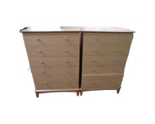 A pair of Morris furniture pine effect six drawer chests,