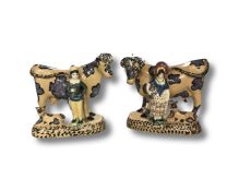 A pair of cream ware cow figures, height 14cm.