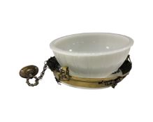 An Art Deco brass light fitting with opaque domed shade