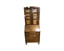 A 20th century bureau bookcase with leaded glass doors,