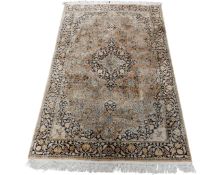 A silk-piled rug, probably Indian, on cream ground, 100cm by 60cm.