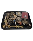 A tray of vintage belt buckles, a pair of field spectacles, a gents watch and a hip flask.