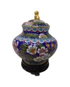 A cloissoné lidded jar on stand.