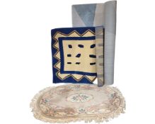 A fringed Chinese oval rug together with three contemporary rugs.