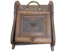 An Edwardian oak coal receiver.