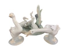 A Nao china figure group of ducks together with two Lladro geese.
