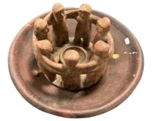 A pottery bowl on metal stand together with a pottery candle holder.
