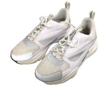 A pair of Dior Homme white trainers.