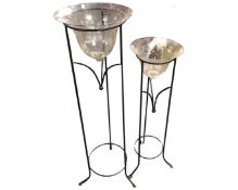 Two metal stands with glass bowls.
