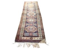 A Caucasian design fringed runner, 94cm by 292cm.