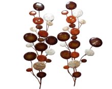 Two metal pebble wall plaques