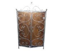 A Barker and Stonehouse polished steel and mahogany double door wardrobe