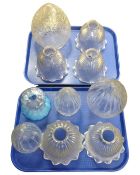 An antique brass hanging light fitting together with three further lights, all with glass shades.