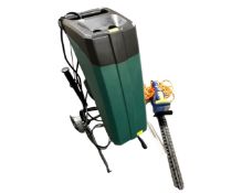 A garden chipper together with an electric hedge trimmer