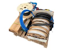 A pallet of rolls of fibre optic cable, flexible tubing, two plastic crates containing wire,