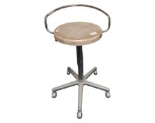 A chrome swivel stool with wooden seat.