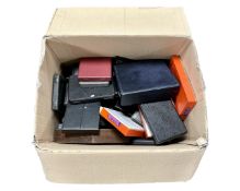 A box containing a large quantity of empty cutlery boxes.