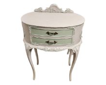 A French style two drawer bedside cabinet on cabriole legs.