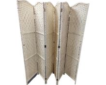 A contemporary wicker folding screen.