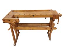 A pine workbench fitted with a vice.
