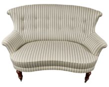 An early 20th century salon two seater settee in striped button upholstery.
