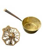 A brass saucepan and a pierced brass stand.