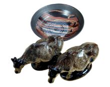 A glazed stoneware fruit bowl together with a pair of cow ornaments.