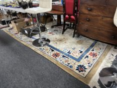 A Chinese carpet on beige ground, 335cm by 215cm.