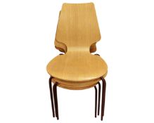 A set of four oak effect stacking chairs.