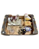 A box containing a cottageware teapot, glass decanters, a pair of wine glasses,