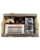 A box containing Hornby HM 2000 power controller and further model railway controllers.