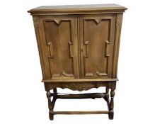 A continental oak double door cabinet on stand.