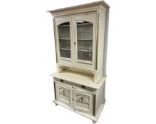 A 19th century painted glazed double door bookcase fitted with cupboards and drawer beneath.