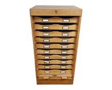 A Danish light oak shutter front office cabinet fitted with internal drawers.