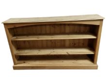 A pine open bookshelf.