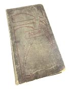 An antiquarian postcard album containing humorous postcards.