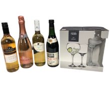 Four bottles of assorted red and white wine together with a boxed pair of gin glasses.