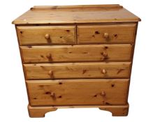 A contemporary pine chest of five drawers.