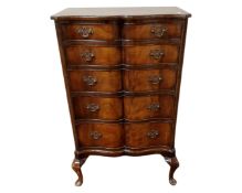 A reproduction mahogany serpentine front chest of five drawers.