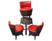 A barrel table together with three wood and red vinyl barrel chairs.