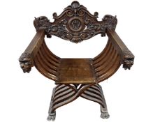 A 19th century carved beech Savonarola armchair.