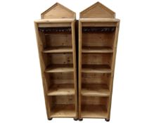 A pair of antique pine narrow open bookshelves